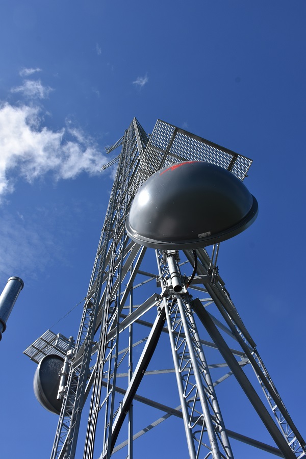 a communications tower and blue sky