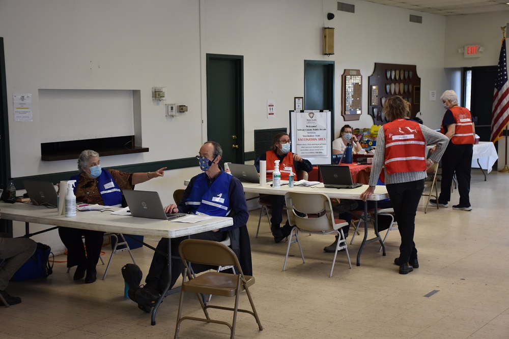 a group of people sitting at desks in a room