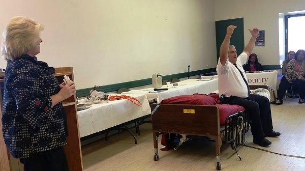 man sitting on bed giving fire safety demonstration